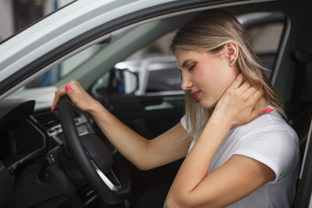Woman holds her neck after suffering whiplash