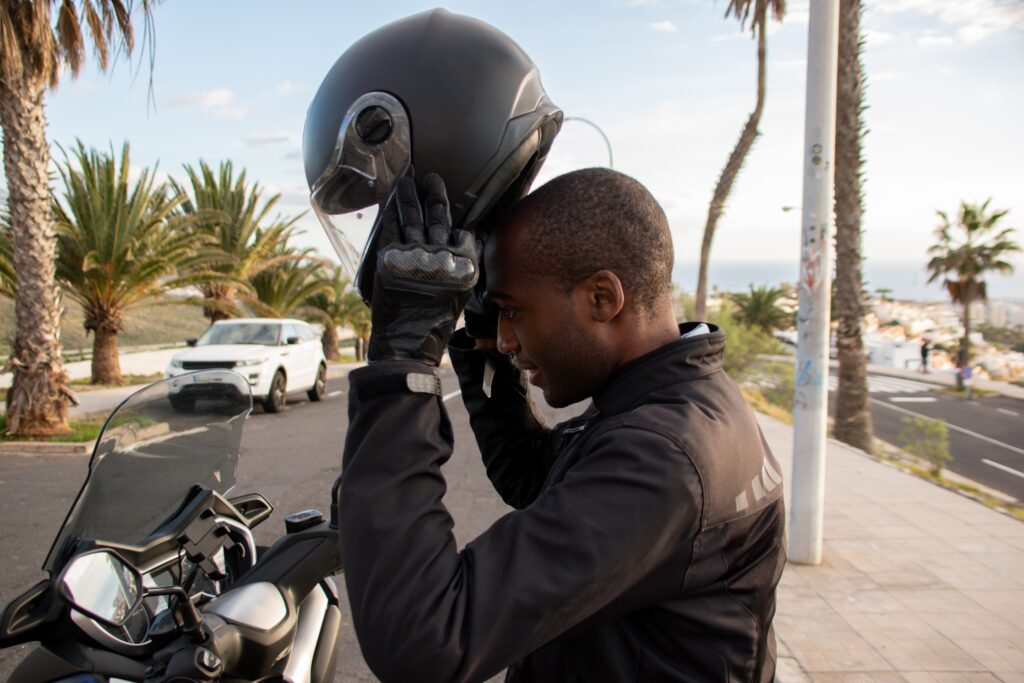 Man putting on a motorcycle helmet