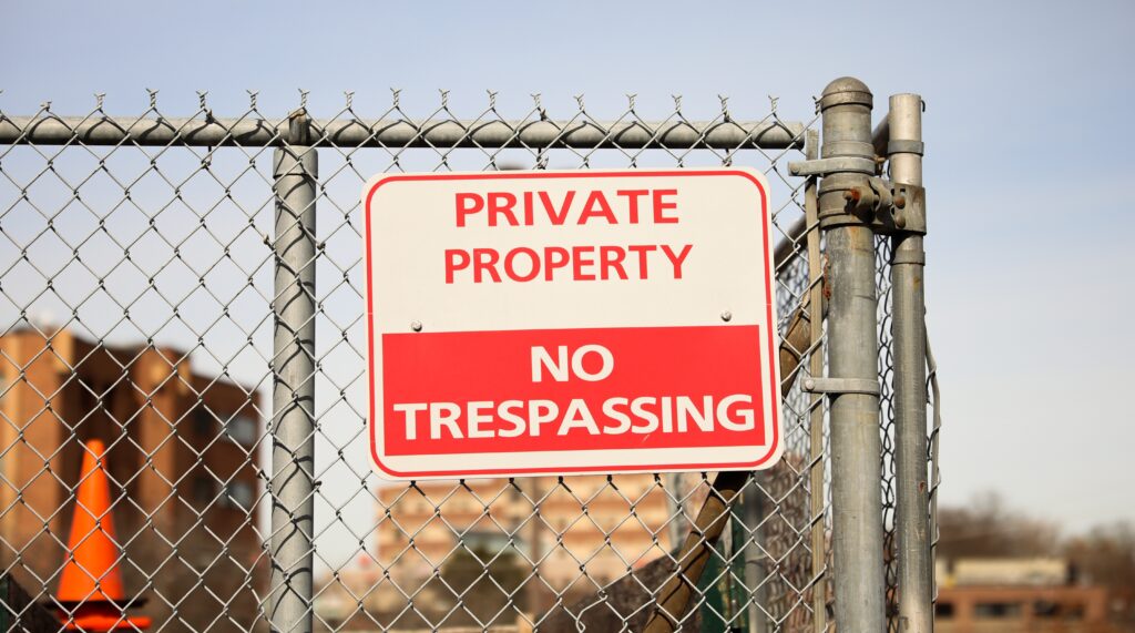 Trespassing sign on fence.