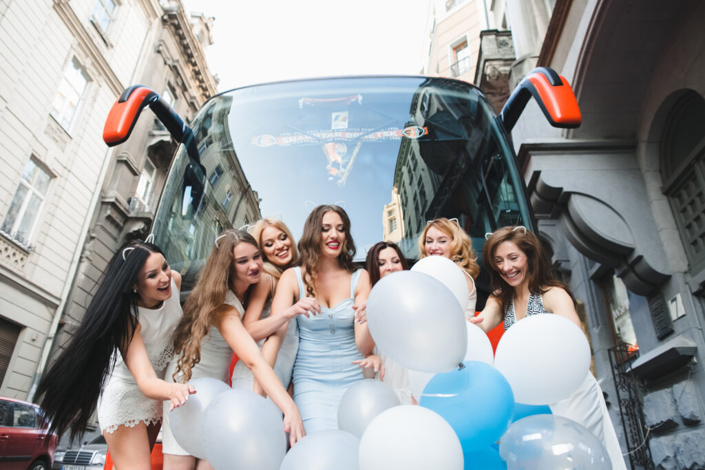 Women celebrate outside a California party bus 